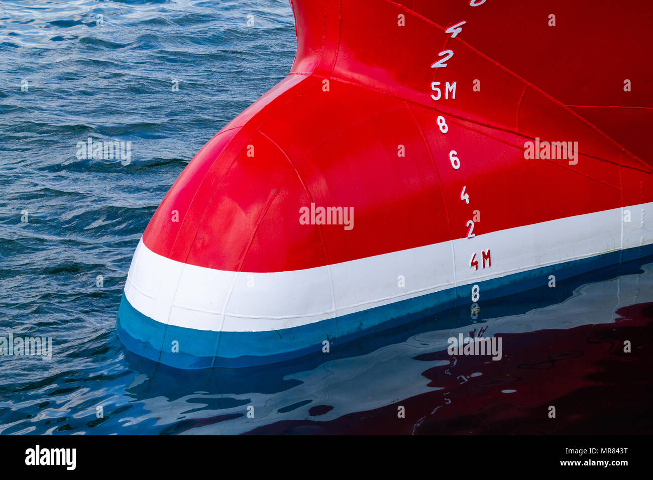 bulbous bow of a freshly painted trawler showing the draft or draught marks on the ships hull. Stock Photo