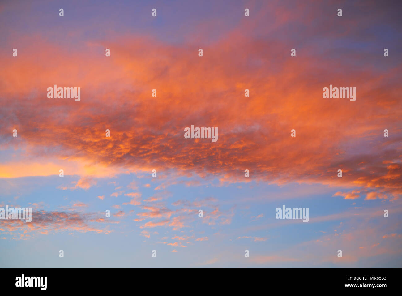 Sunset sky with orange clouds and blue background skies Stock Photo
