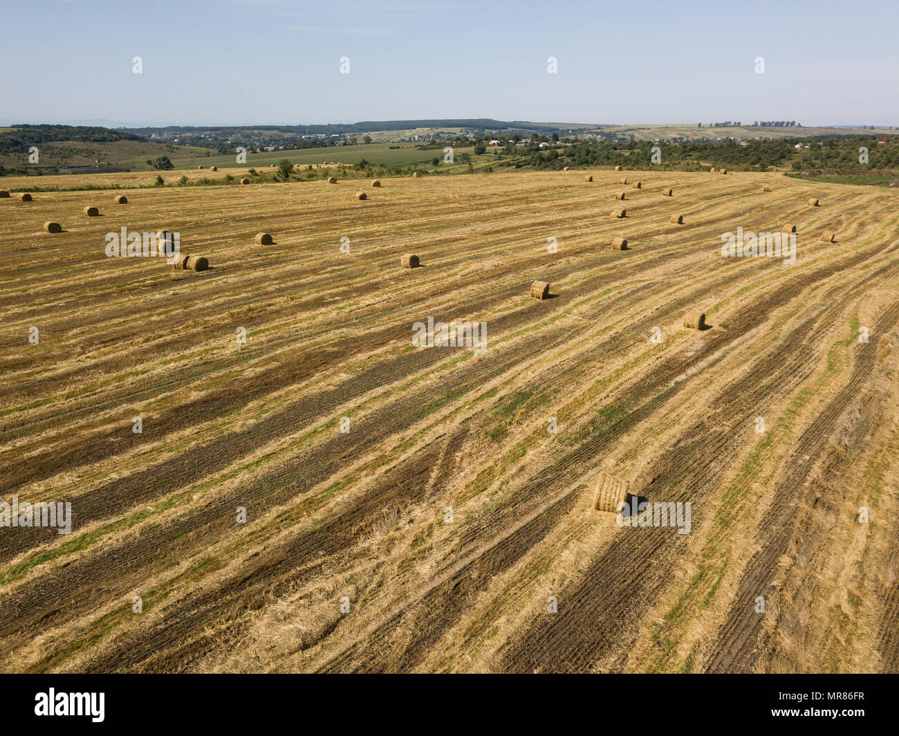Aerial view to harvested field with straw bales in summer Stock Photo ...
