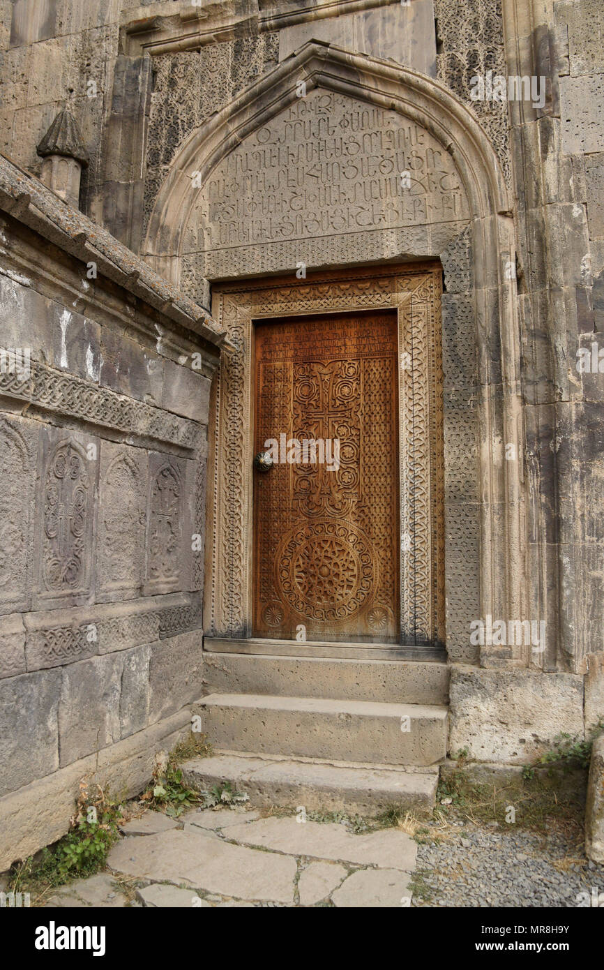 An intricately carved wood door leads into the 9th-century church of Surp Poghos-Petros (St. Paul and St. Peter) at Tatev Monastery, Armenia. Stock Photo