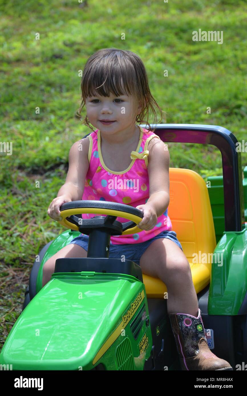 Toddlers first John Deere. Stock Photo