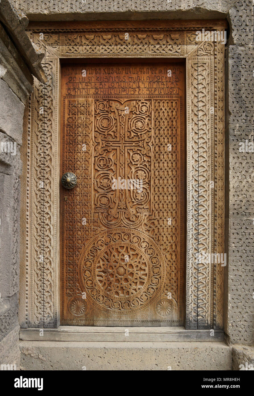 An intricately carved wood door leads into the 9th-century church of Surp Poghos-Petros (St. Paul and St. Peter) at Tatev Monastery, Armenia. Stock Photo