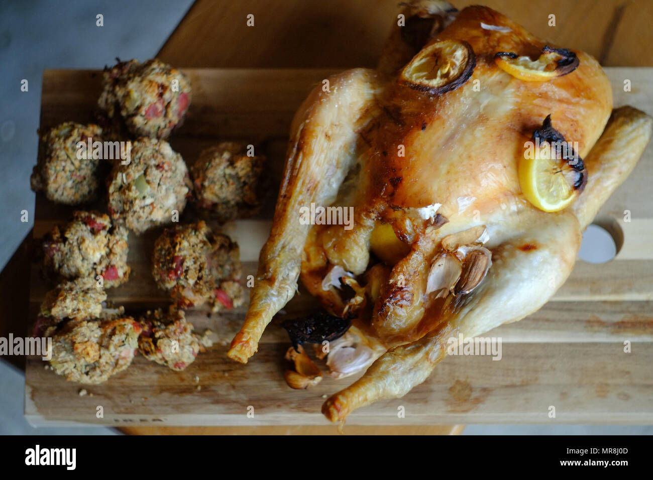 Roast chicken and stuffing on a chopping beard. Stock Photo