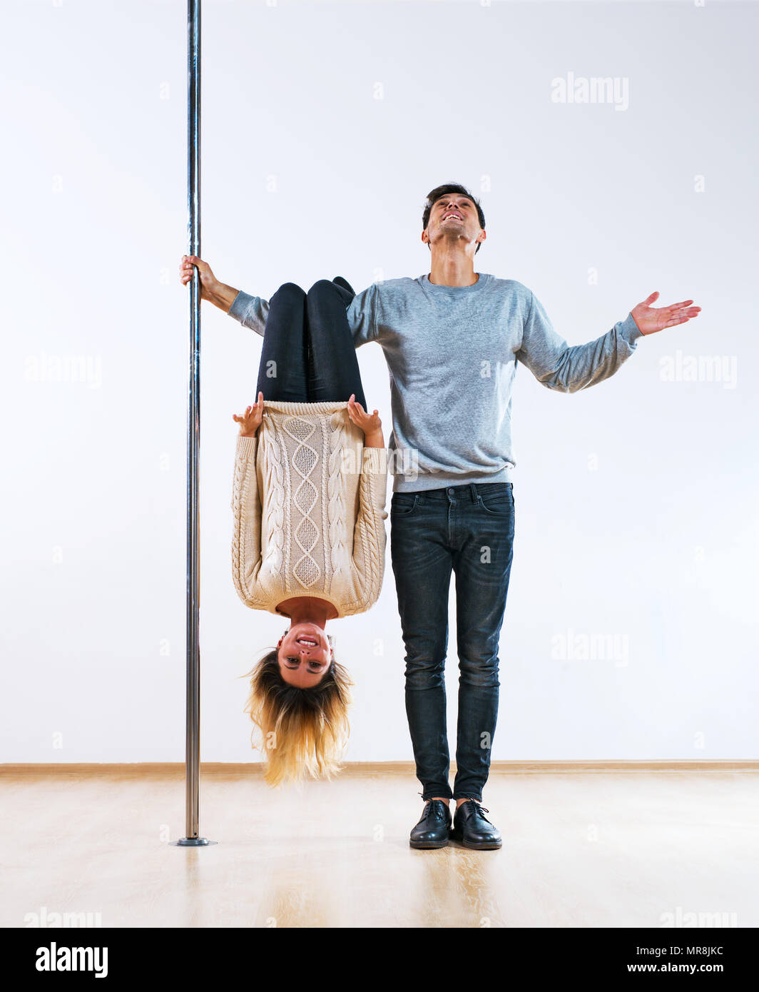 Young man and woman pole dancers in casual clothing happy emotions Stock Photo