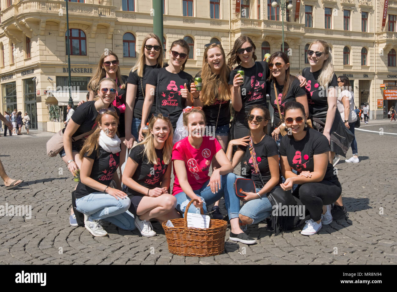 A bride to be from Salzburg, Austria poses with her bridesmaid friends & family at Republic Square in Prague, Czech Republic. Stock Photo
