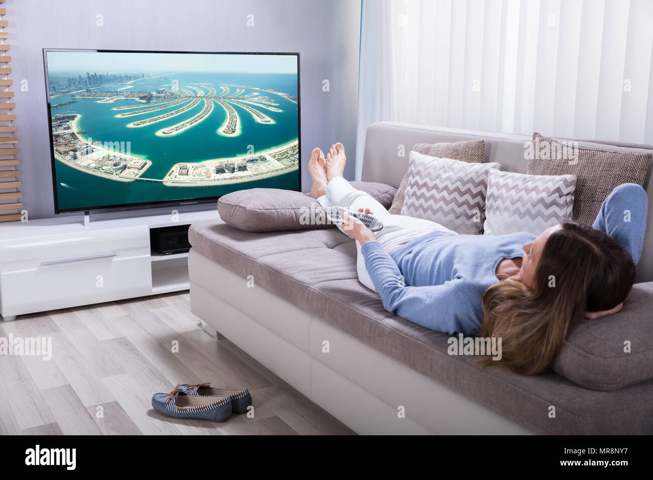 Old lady watching tv on sofa hi-res stock photography and images - Alamy