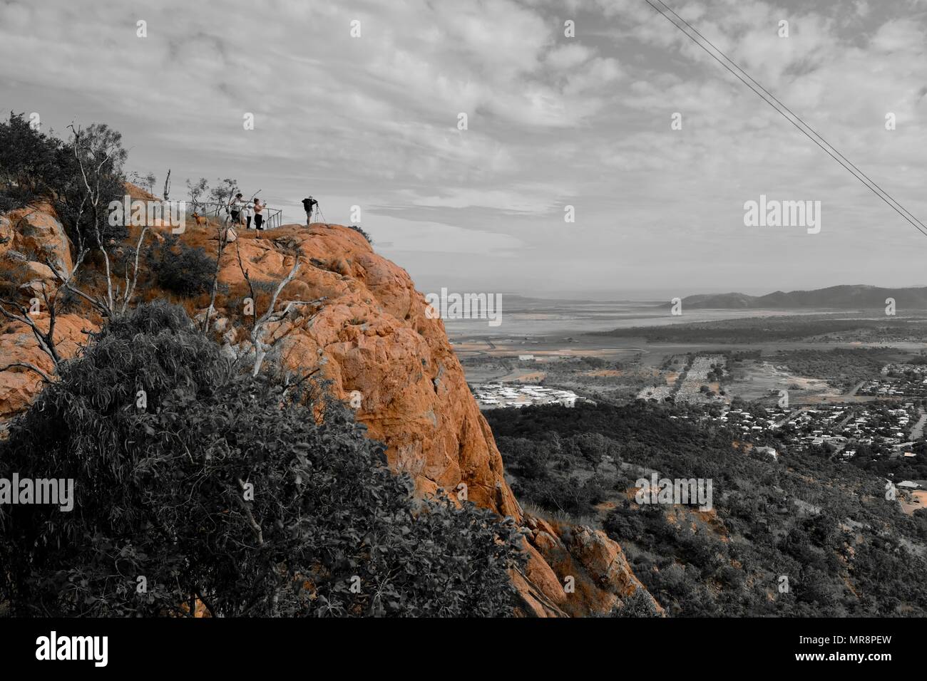 Man taking photograph of Townsville and magnetic island from Castle Hill, Castle Hill QLD 4810, Australia Stock Photo