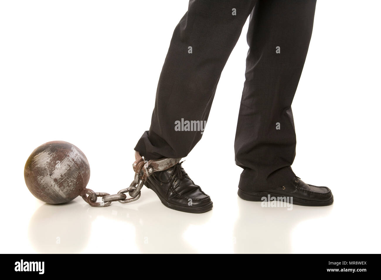 Feet isolated on white, hindered by a ball and chain. Concepts. Stock Photo