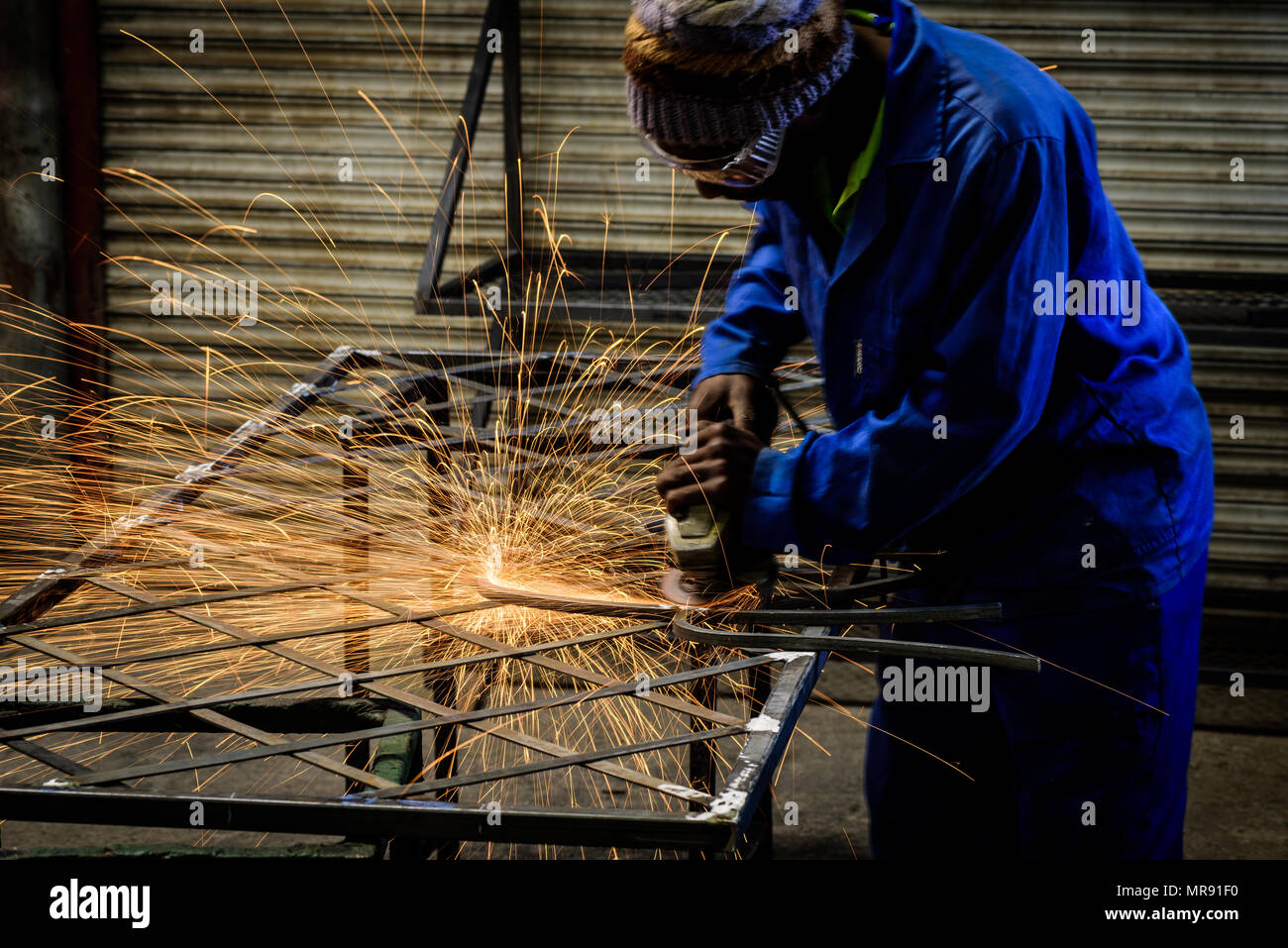 A metal worker on an Eastern Cape farm in South Africa. Farmers often establish small businesses to help pay for the costs of farming Stock Photo