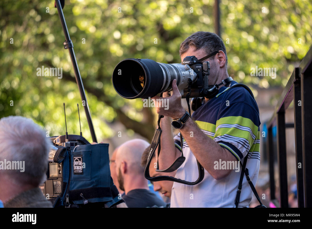 Photographer Joel Goodman in Albert Square during the Manchester Together concert remembering the victims of the Arena bomb attack in Manchester, Britain, on May 22, 2018. Prince William and British Prime Minister Theresa May joined other politicians, as well as family members of those killed, and first responders to the scene of the terror attack, whilst thousands of people gathered in Manchester Tuesday on the first anniversary of a terror attack in the city which left 22 people dead. Stock Photo
