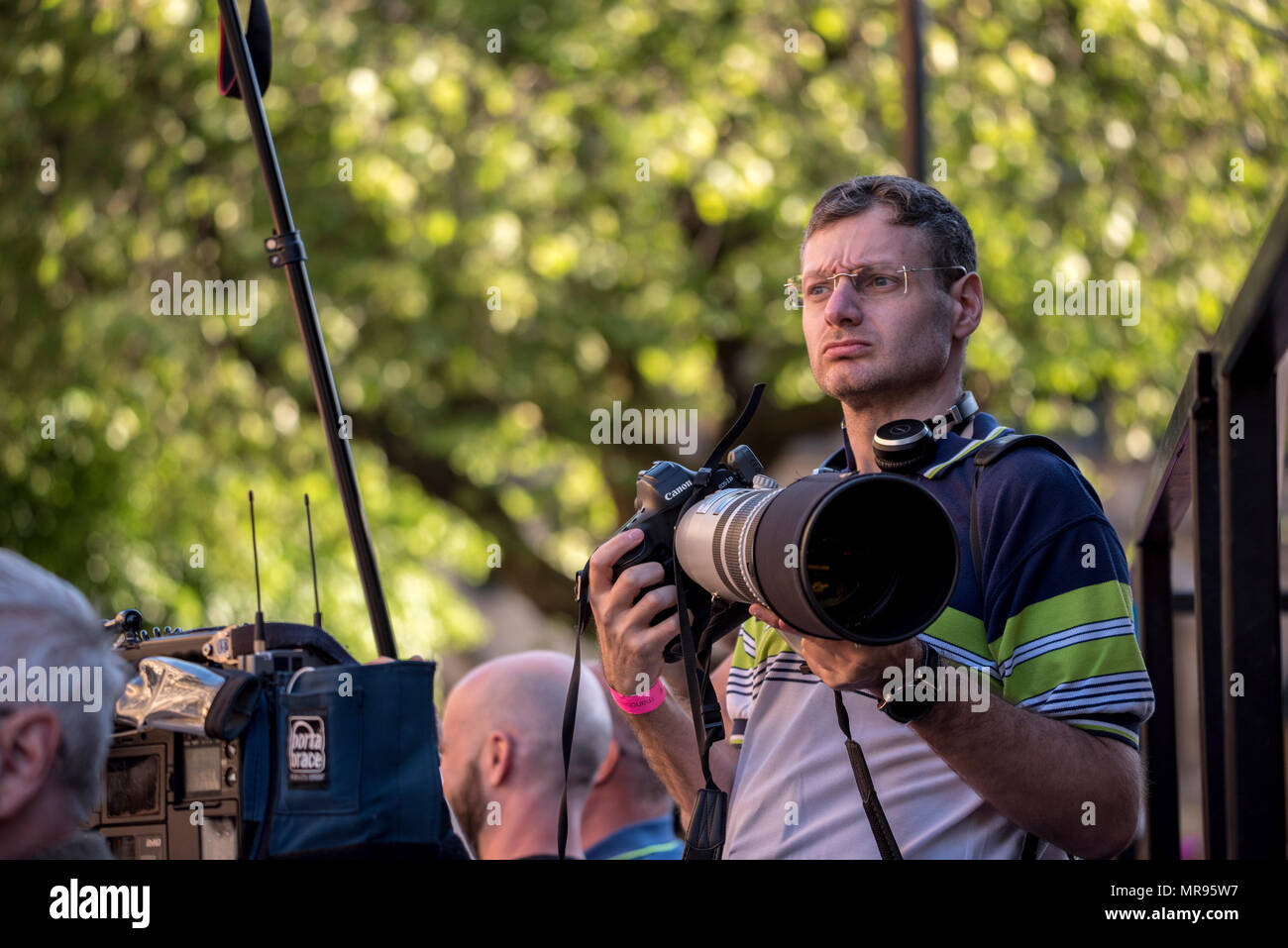 Photographer Joel Goodman in Albert Square during the Manchester Together concert remembering the victims of the Arena bomb attack in Manchester, Britain, on May 22, 2018. Prince William and British Prime Minister Theresa May joined other politicians, as well as family members of those killed, and first responders to the scene of the terror attack, whilst thousands of people gathered in Manchester Tuesday on the first anniversary of a terror attack in the city which left 22 people dead. Stock Photo