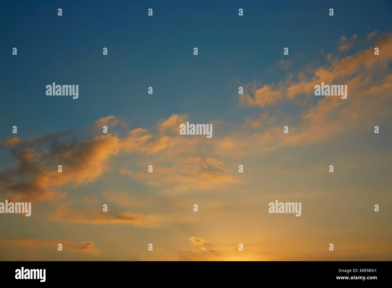 Sunset sky orange clouds on blue sky at dusk Stock Photo - Alamy
