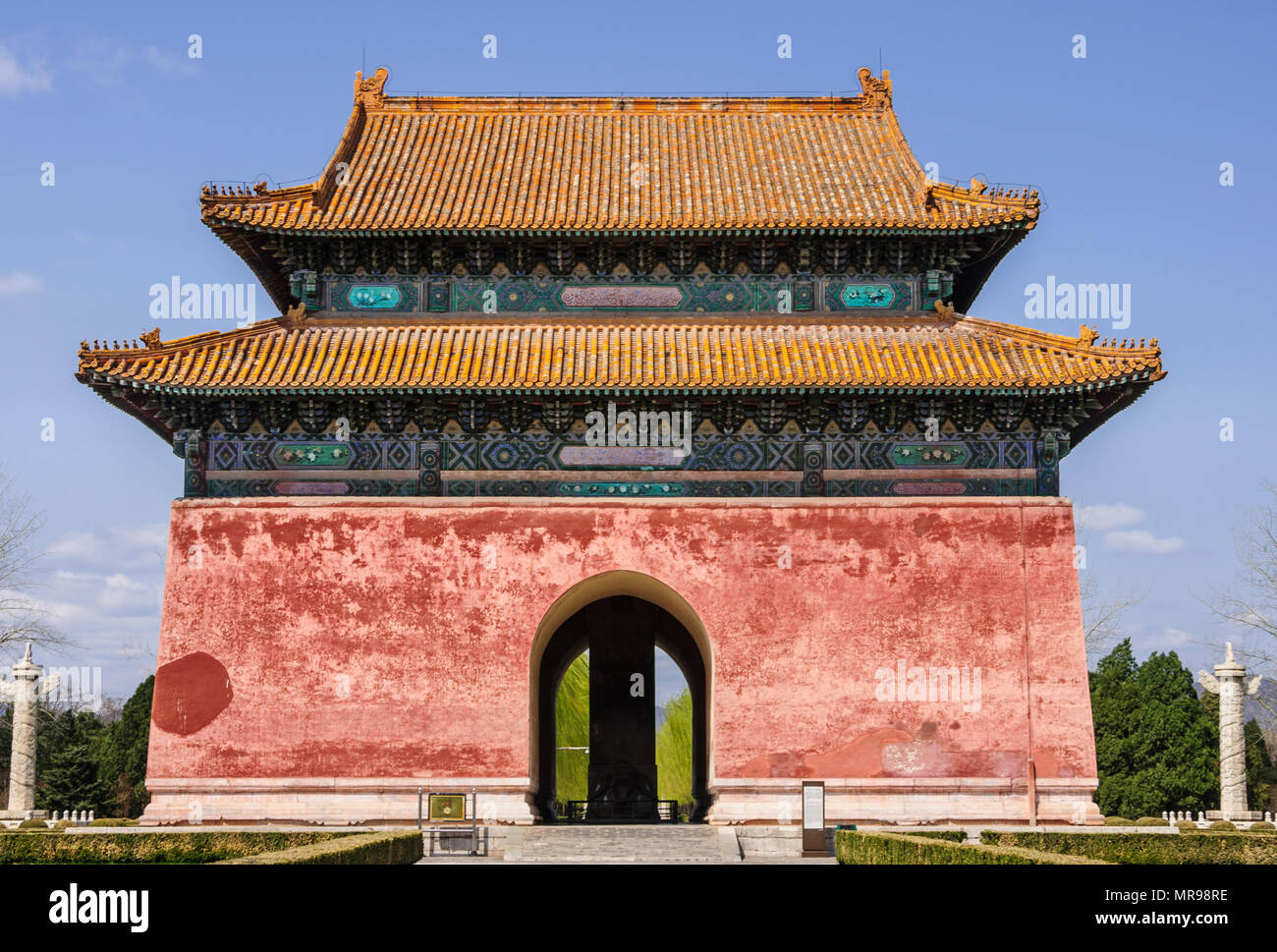 Beijing, China - April 28, 2010: Ming Dynasty Tombs domain, or Ming Changling. Large orange-roofed, red entrance Stele hall and gate under blue sky an Stock Photo