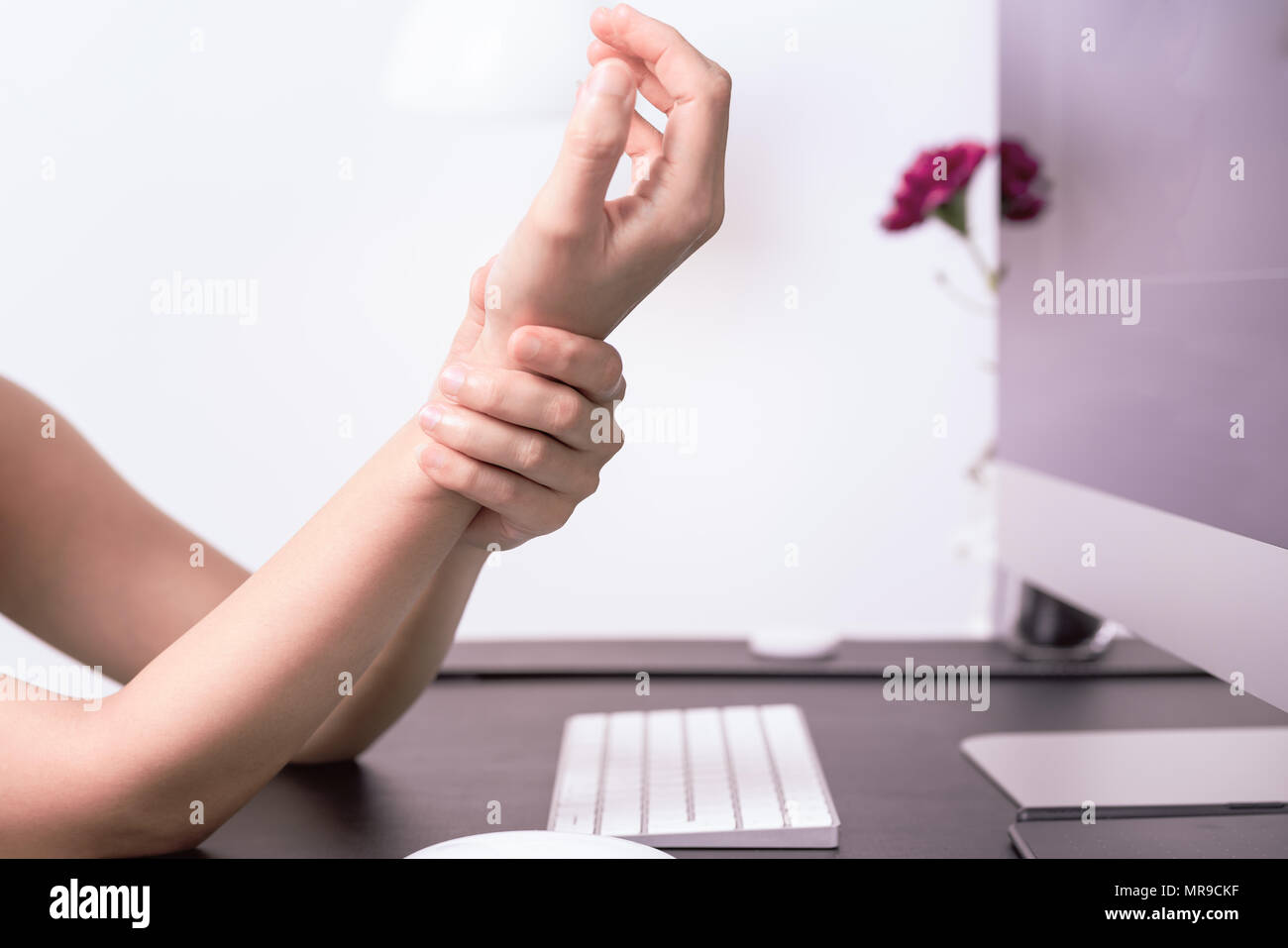 woman wrist arm pain long use mouse at office. office syndrome