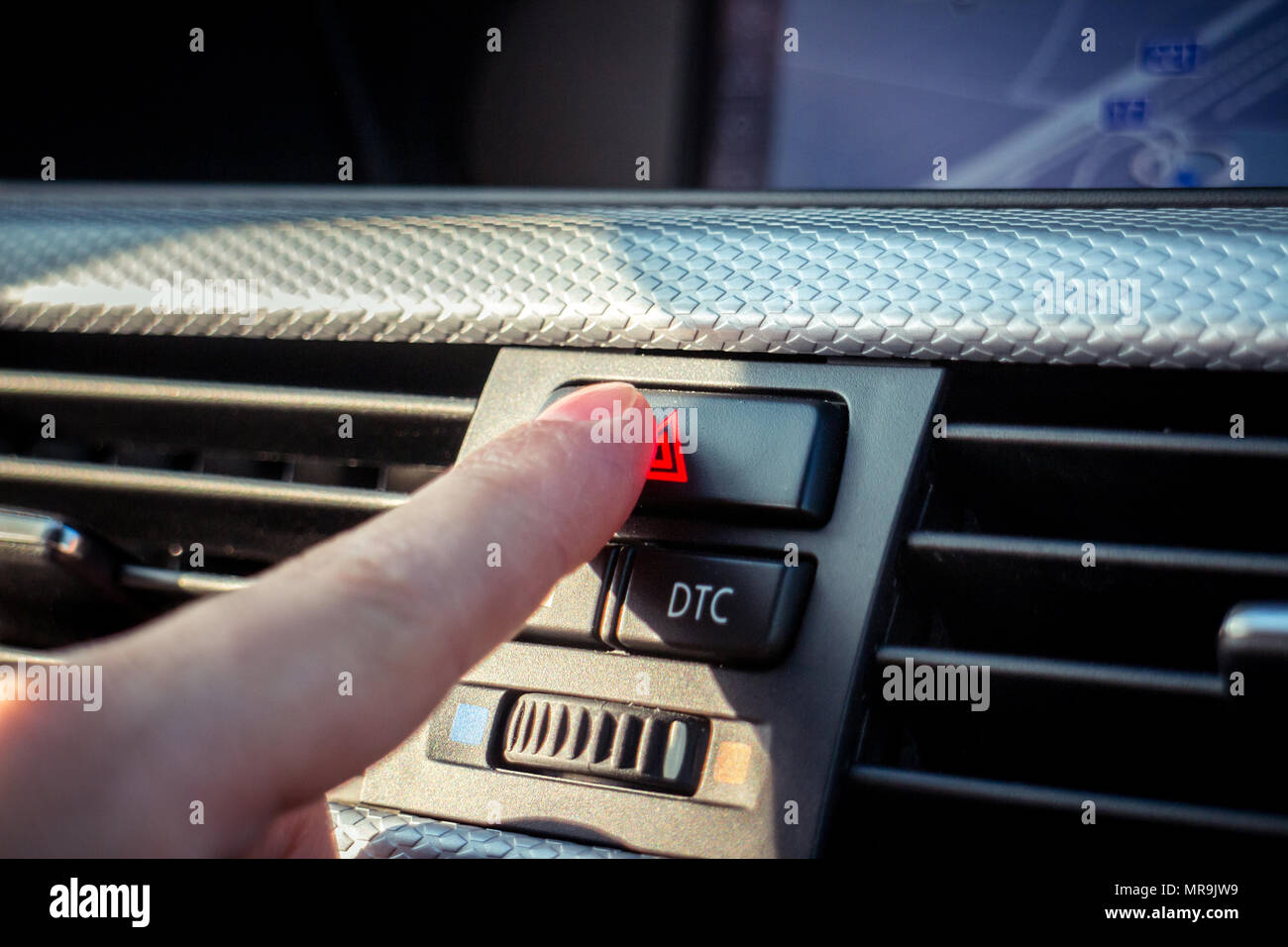 Pressing the hazard button on modern car dashboard Stock Photo Alamy