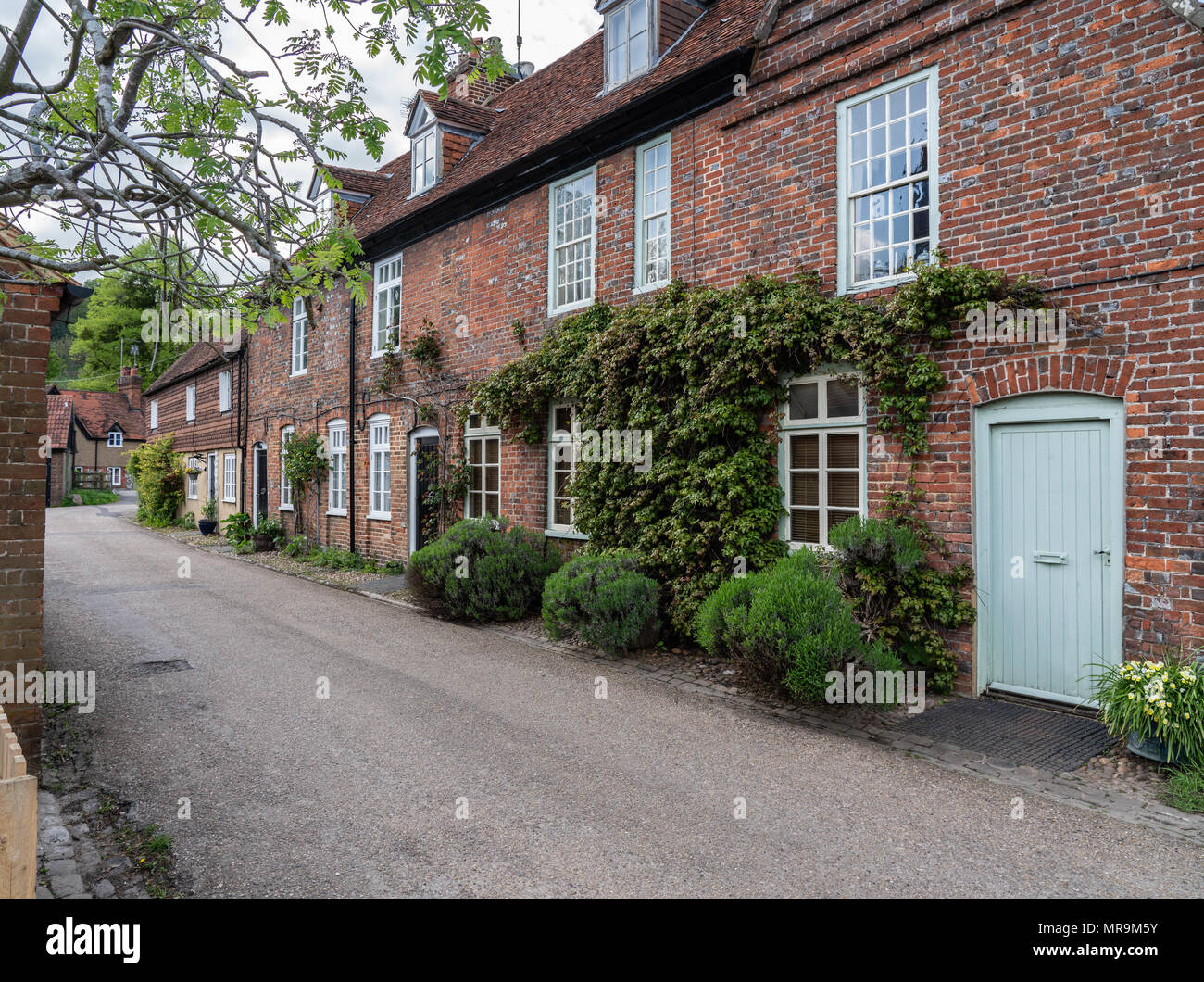 Pretty street of brick houses in village of Hambleden Stock Photo