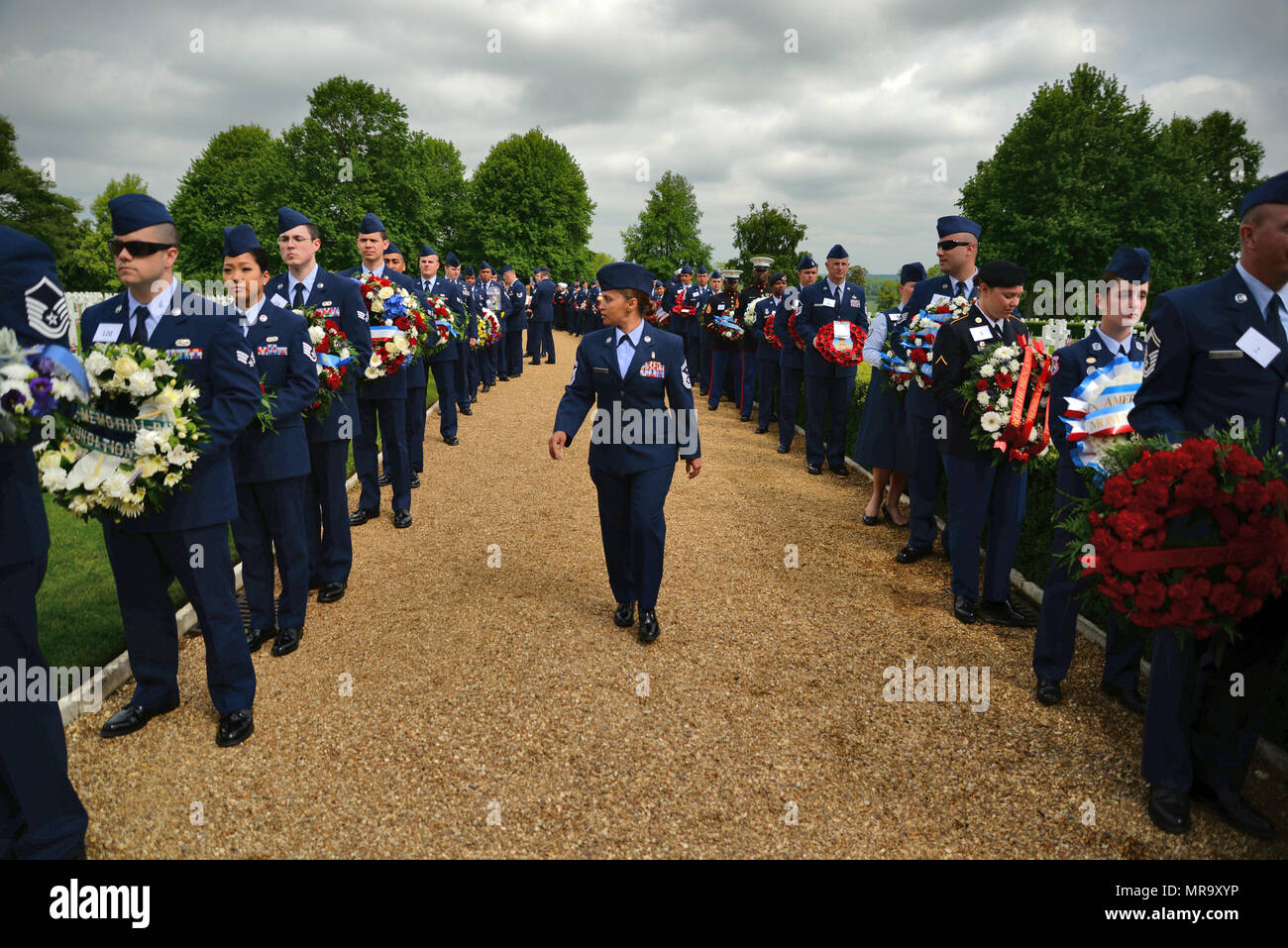 U.S. Air Force Senior Master Sgt. Arwa Cavendar, 100th Aircraft Maintenance Squadron first sergeant, provides a pre-ceremony inspection prior to the Madingley Memorial Day Ceremony May 29, 2017, at Madingley Memorial Cemetery in Cambridge, England. The event included a wreath laying, fly overs and a firing of volleys. (U.S. Air Force photo by Senior Airman Christine Groening) Stock Photo
