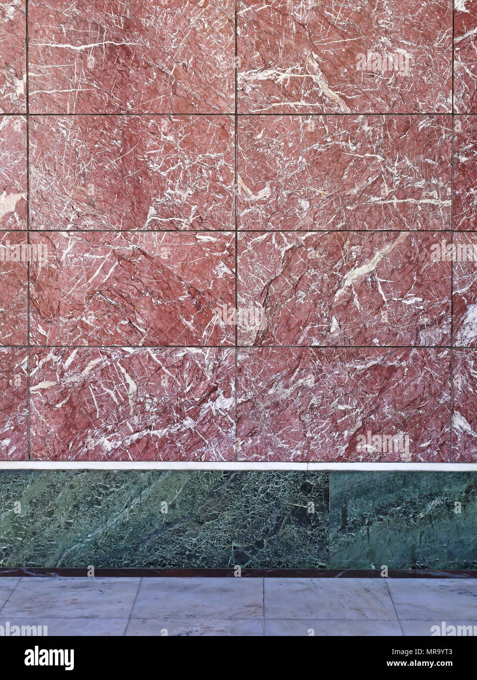 Finest marble tiles in burgundy color wall Stock Photo - Alamy