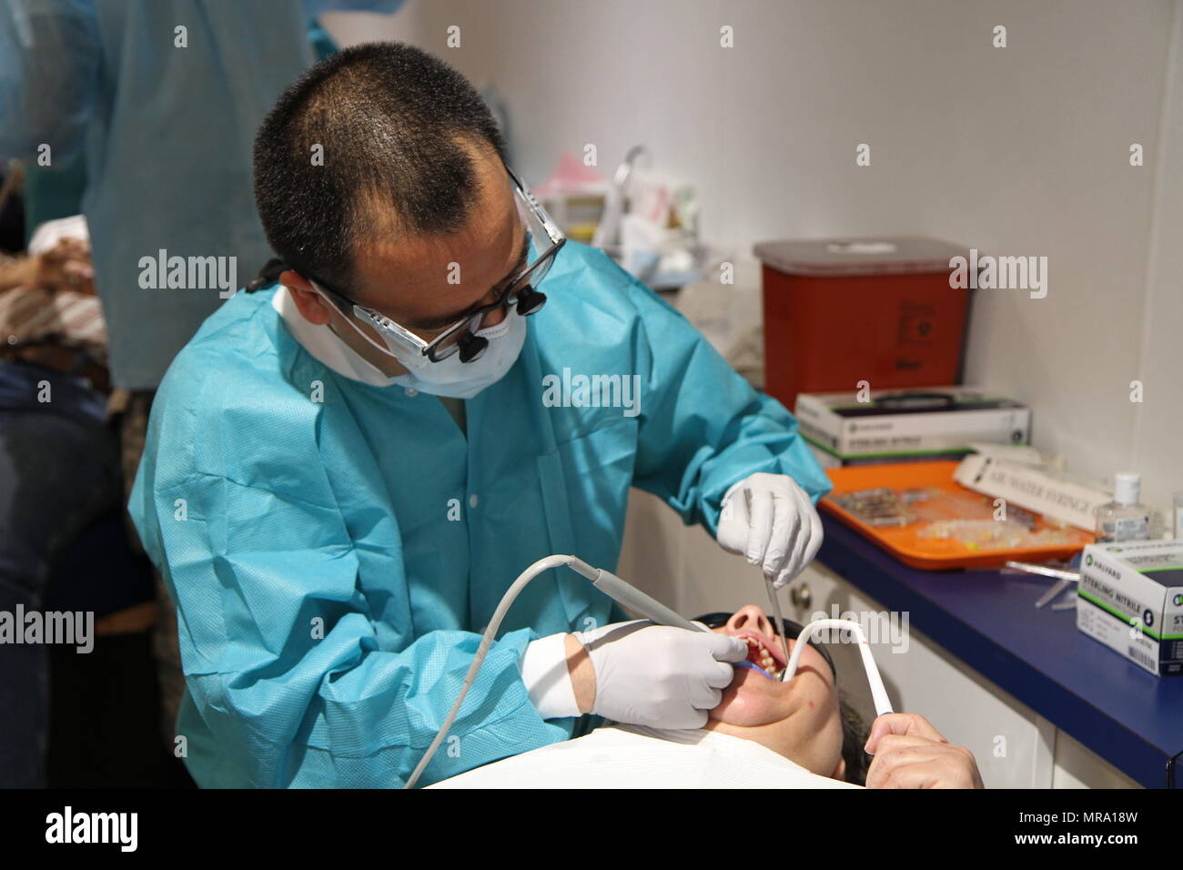 Appalachia IRT Dental Officer in Charge from the 455th Dental Company in Devens Reserve Forces Training Area, Mass., Maj. Takashi Komabayashi, provides dental care during Appalachia IRT 2017 which took place from May 14-27 at the Wise County Fairgrounds in Wise, Va. Stock Photo