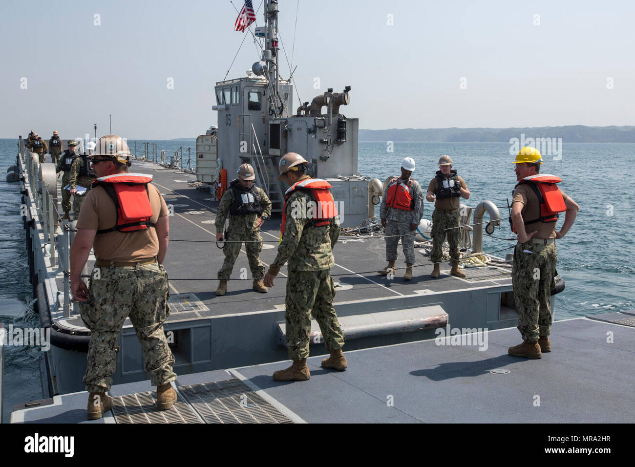 U.S. Marines, Sailors, and Coast Guardsmen aboard the USNS Pililaau conduct loading and off loading of cargo and gear during Combined Joint Logistics Over The Shore (CJ LOTS) Exercise in the Republic of Korea (ROK) in the Sea of Japan, Pohang, Korea, April 13, 2017. CJ LOTS is an exercise designed to train U.S. and ROK service members to accomplish vital logistical measures in a strategic area while strengthening communication and cooperation between the U.S. and ROK alliance. Stock Photo