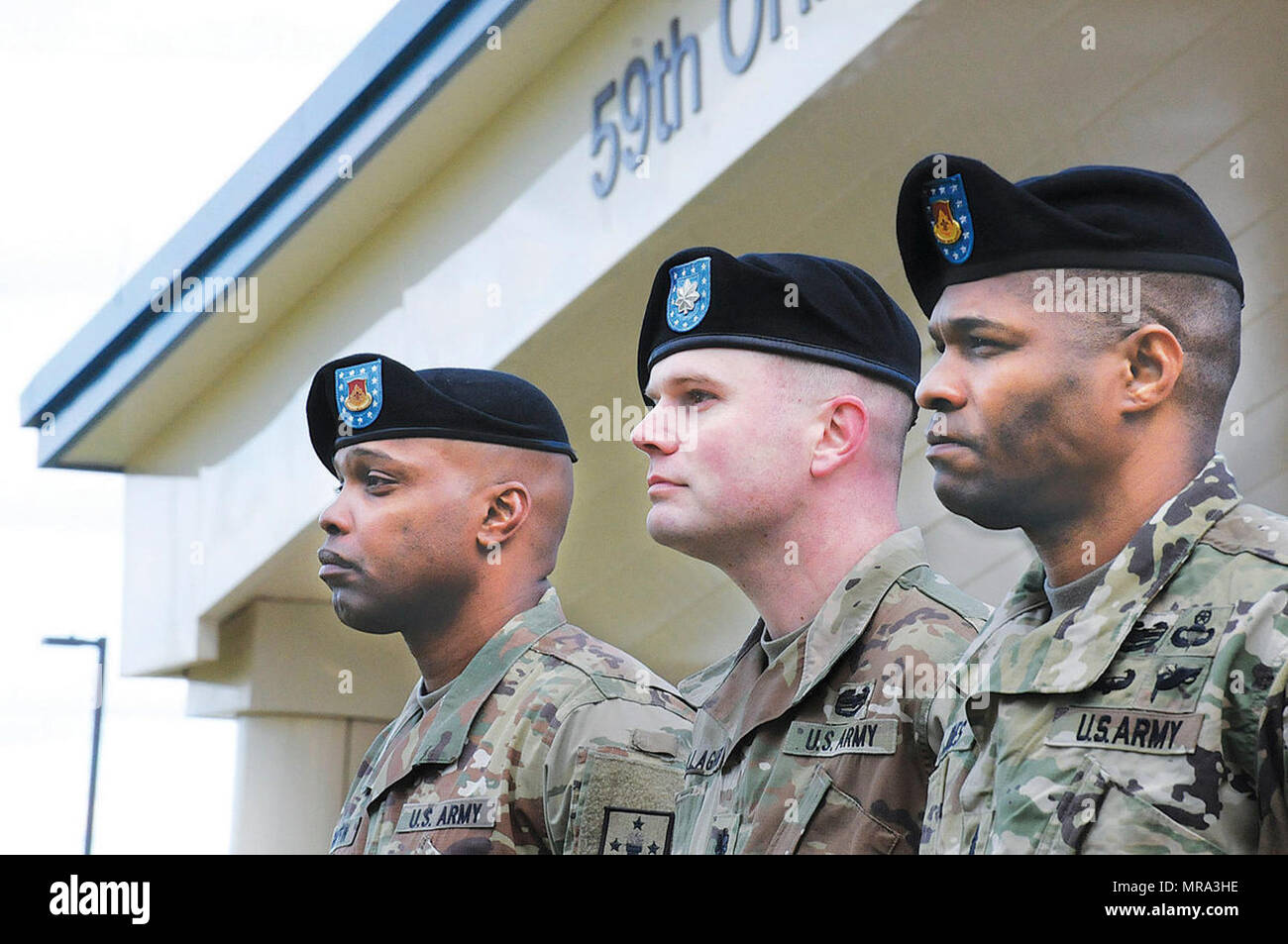 From right to left, Command Sgt. Maj. Dejarius O. Jones, incoming 832nd Ordnance Battalion CSM, Lt. Col. Timothy M. Gallagher, battallion commander, and CSM Garrick E. Griiffin, outgoing battalion CSM, stand at the podium during the 832nd Ord. Bn. Change of Responsibility Ceremony April 7 at Whittington Field. Stock Photo
