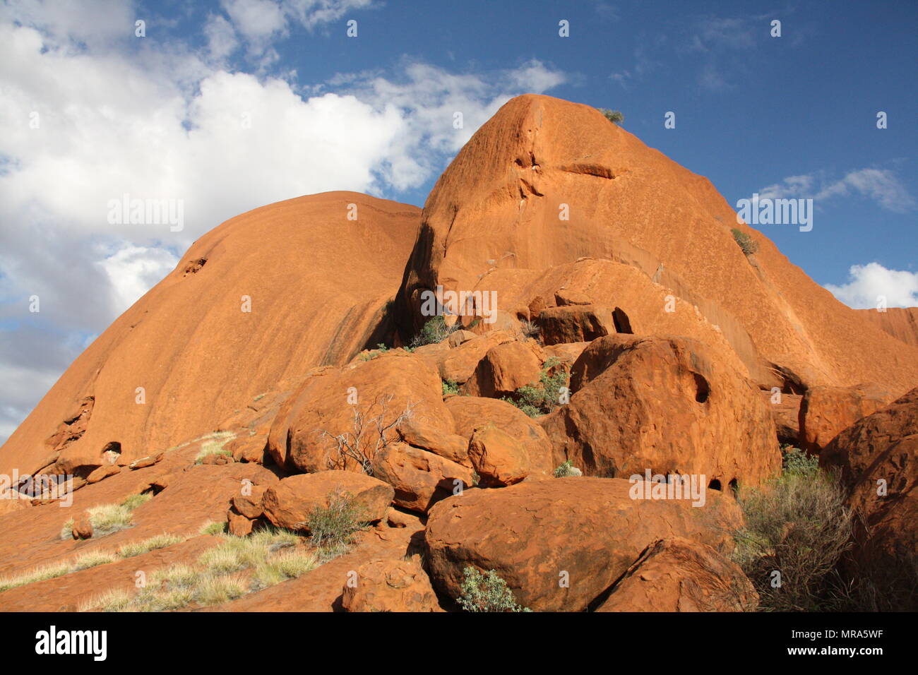 The red sandstone of Uluru glowing in the sunlight. Stock Photo
