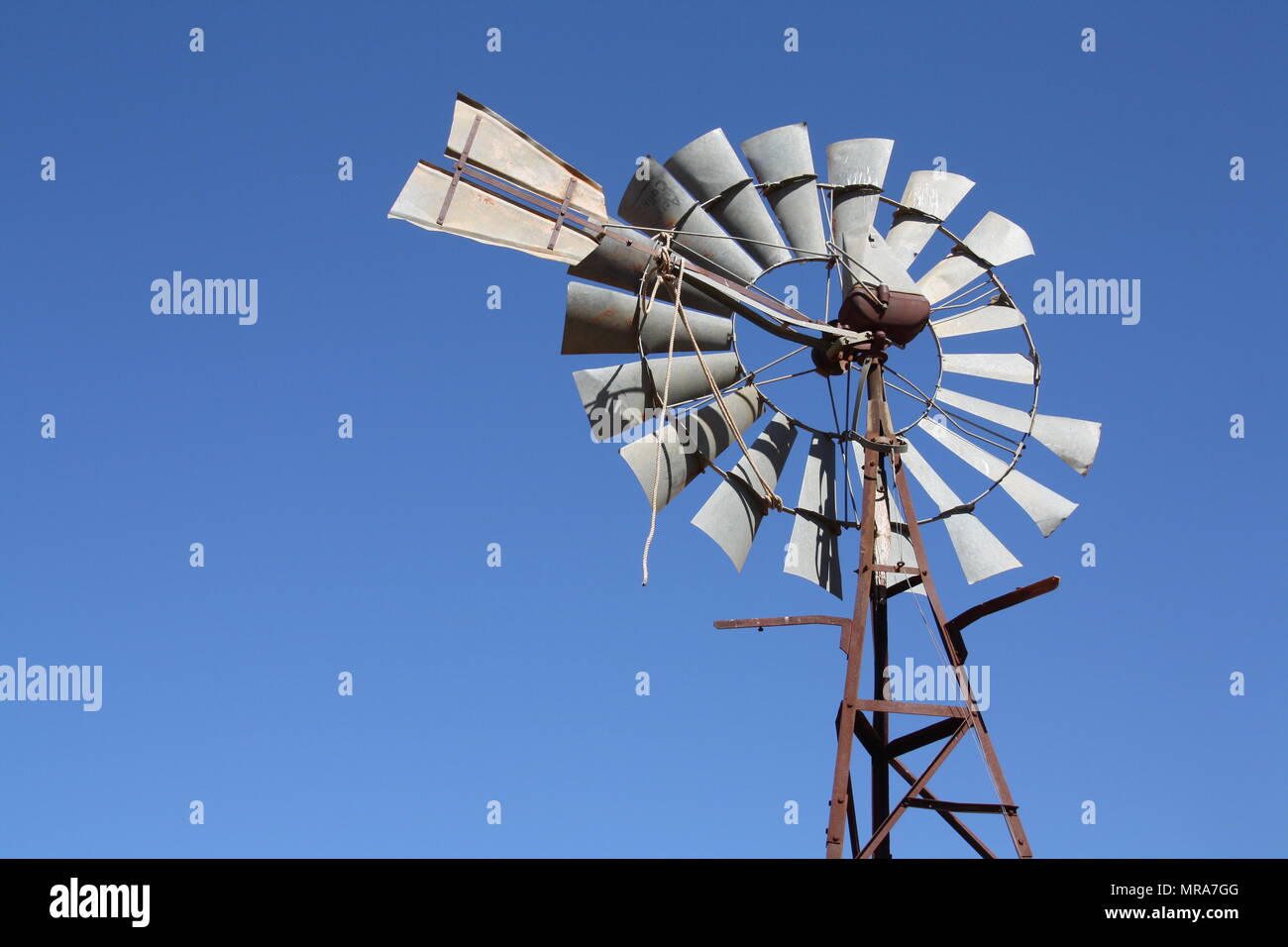 Outback windmill at Curtin Springs Cattle Station in the Northern Territory. Stock Photo