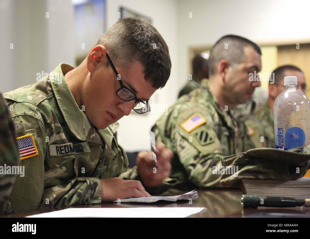 U.S. Army Sgt. Taylor Redmond, assigned to 311th Signal Command (Theater), 307th Signal Battalion, takes notes during the voice communications and tactical radio training for the Network Enterprise Technology Command's (NETCOM) Best Warrior Competition at Fort Huachuca, Az., May 13, 2017. The training is given to prepare the Soldiers competing in the 2017 NETCOM Noncommissioned Officer and Soldier of the year. (U.S. Army photo by Pfc. Elizabeth Brown) Stock Photo