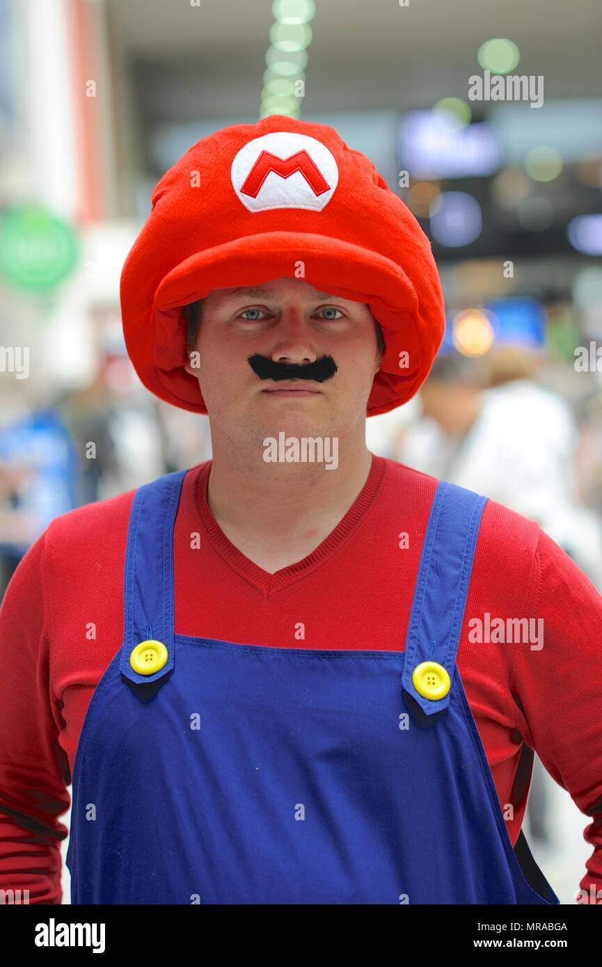 London, UK, 25 May 2018. A cosplay enthusiast dressed as the game character Mario on the opening day of MCM London Comic Con at the ExCel Centre in East London, UK.  Tens of thousands of cosplay enthusiasts  attended the show and more than 130,000 are expected to walk through the doors by the end of the three-day event which finishes on Sunday. Credit: Michael Preston/Alamy Live News Stock Photo