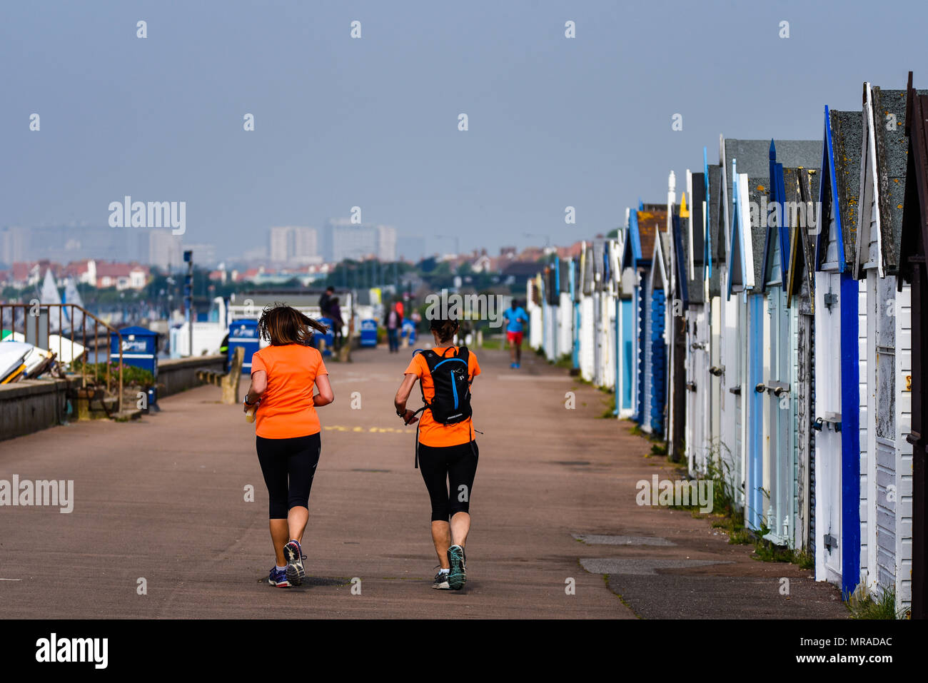 Thorpe Bay seafront, Essex. Joggers take to the esplanade passing beach