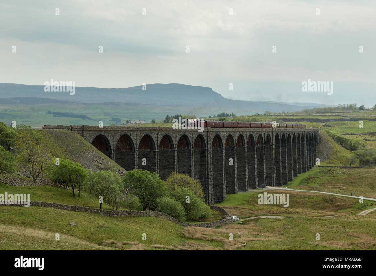 Ribblehead, United Kingdom. 26th May 2018. Steam locomotive 45699 'Galatea' crosses Ribblehead Viaduct on the Settle to Carlisle line with 'The Hadrian' steam charter. Credit: Andrew Plummer/Alamy Live News Stock Photo
