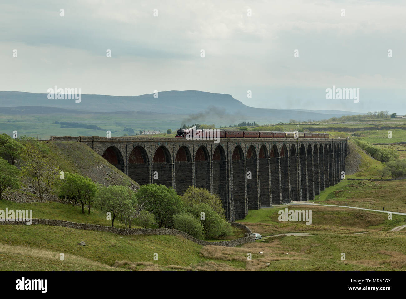 Ribblehead, United Kingdom. 26th May 2018. Steam locomotive 45699 'Galatea' crosses Ribblehead Viaduct on the Settle to Carlisle line with 'The Hadrian' steam charter. Credit: Andrew Plummer/Alamy Live News Stock Photo