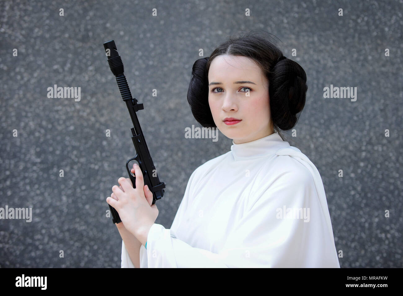 London, UK. 26 May 2018. A girl dressed as Princess Leia from Star Wars  joins cosplayers attending day two of MCM Comic Con at Excel in East  London. Thousands of fans of