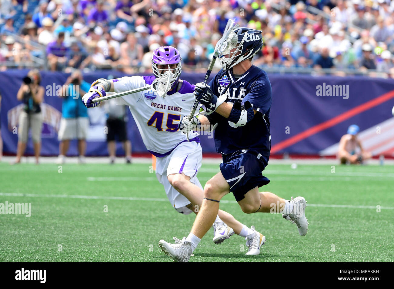 Foxborough, Mass. 26th May, 2018. Albany Great Danes defender AJ Kluck (45) tries to check Yale Bulldogs attackman Lucas Cotler (9) during the NCAA Division I Lacrosse semi final between Yale and Albany, held at Gillette Stadium, in Foxborough, Mass. Yale defeats Albany 20-11. Eric Canha/CSM/Alamy Live News Stock Photo