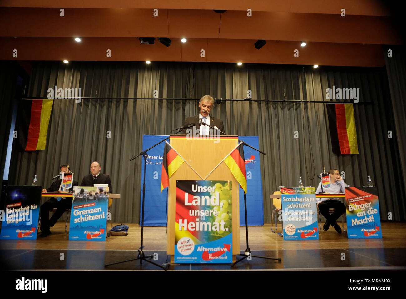 Jockgrim, Germany. 26th May 2018. The parliamentary leader of the AfD party in the Landtag (parliament) of Rhineland-Palatinate Uwe Junge speaks on the podium. The parliamentary group of the right-wing populist AfD (Alternative for Germany) party of Rhineland-Palatinate celebrated the 2nd anniversary of their entry into the Rhineland-Palatinate state parliament in the 2016 state election in the South Palatinate city of Jockgrim. A counter-protest was organised by several groups outside the venue. Credit: Michael Debets/Alamy Live News Stock Photo