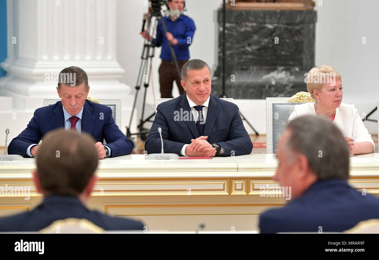 Moscow, Russia. 26 May 2018. Russian Deputy Prime Minister Dmitry Kozak, left, Deputy Prime Minister Yury Trutnev, center, and Minister of Education Olga Vasilyeva during the first meeting of the new government ministers formed by President Vladimir Putin at the Kremlin May 26, 2018 in Moscow, Russia.    (Russian Presidency via Planetpix) Credit: Planetpix/Alamy Live News Stock Photo