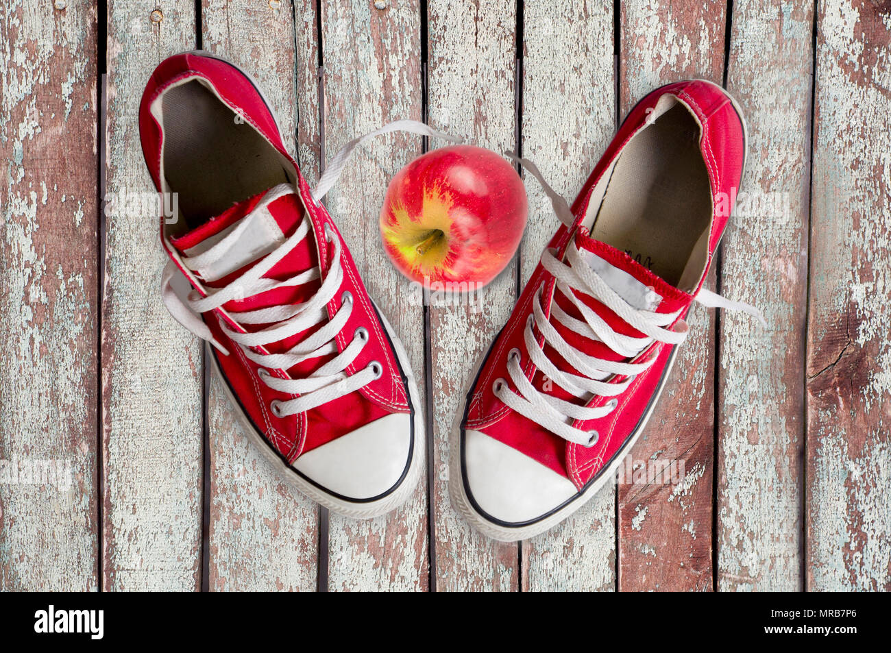 top view of sneakers and apple on wooden palnks Stock Photo - Alamy