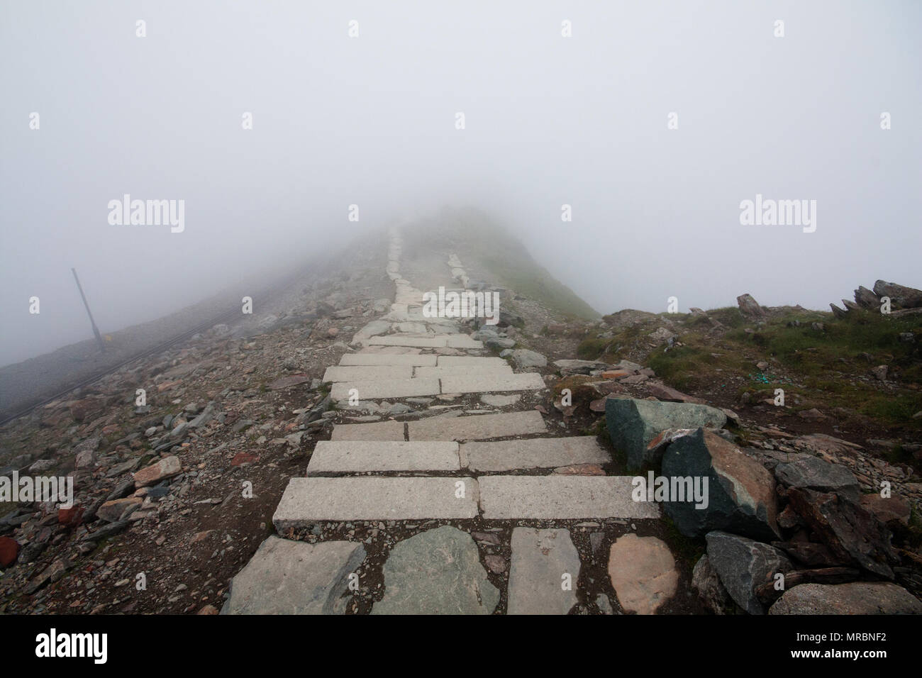 Stone steps on the trail reaching the pack of Snowdon mountain, Snowdonia National Park, Wales. Stock Photo