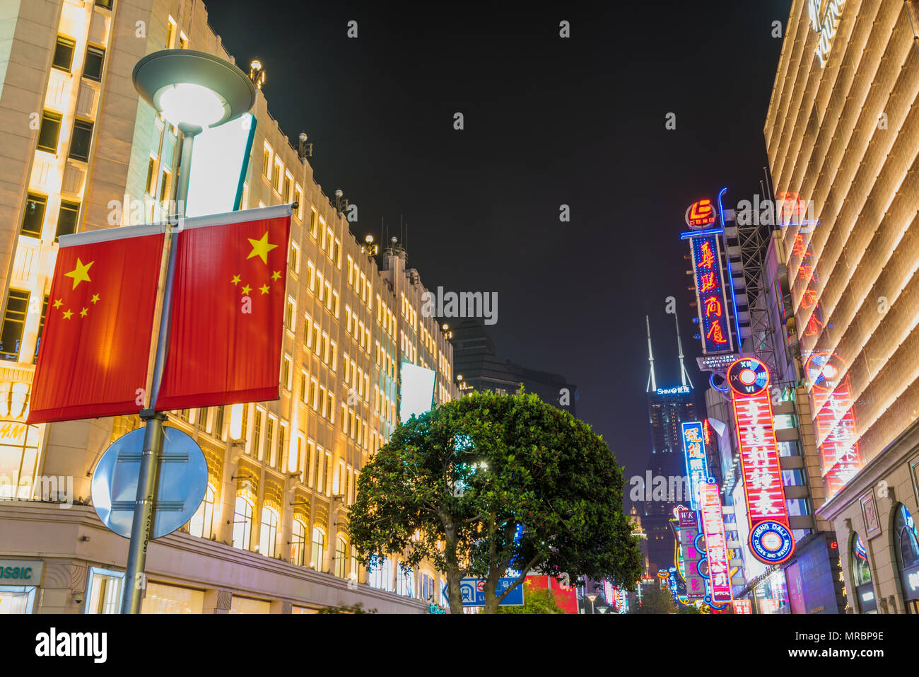 Night scene of the brightly lit shopping street of East Nanjang Road in Shanghai the largest city in China Stock Photo