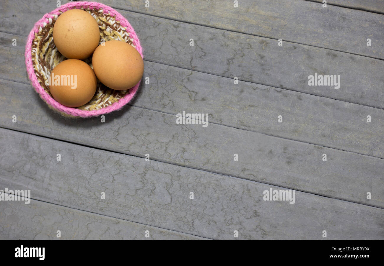 three eggs and nest on gray background Stock Photo