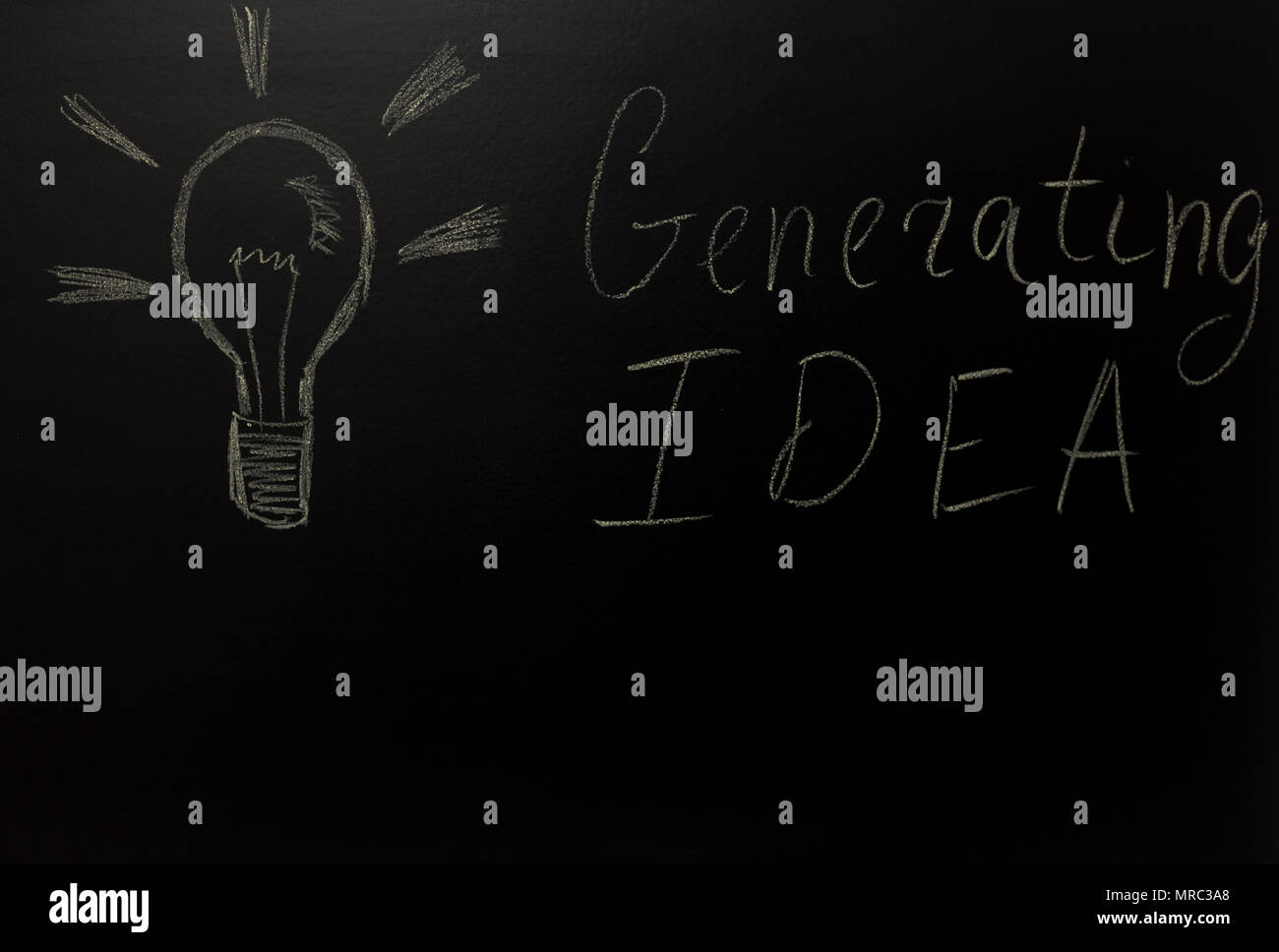 drawn light on blackboard with the text: Generating IDEA Stock Photo