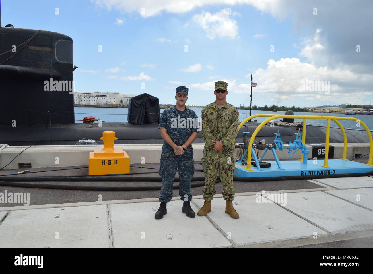 170602-N-WI626-094 APRA HARBOR, Guam (June 2, 2017) Newly promoted brothers Machinist's Mate (Auxiliary) 3rd Class Joseph White, left, and Master-at-Arms 3rd Class Jacob White, assigned to Los Angeles-class attack submarine USS Chicago (SSN 721) and Naval Base Guam Security Forces, respectively, stand together prior to the pair's advancement to 2nd Class Petty Officer. The brothers, native to Gosport, Indiana, are stationed on Guam and joined the Navy seven months apart. (U.S. Navy Photo by Lt. Lauren Spaziano) Stock Photo