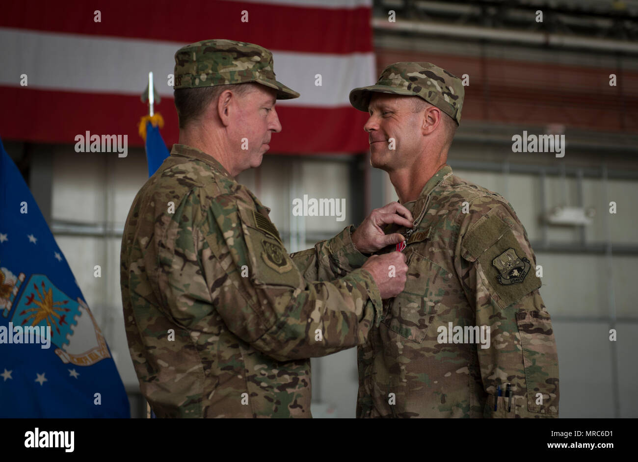 Brig. Gen. Jim Sears, the outgoing 455th Air Expeditionary Wing commander, receives the Bronze Star Medal from Maj. Gen. James Hecker, the 9th Air and Space Expeditionary Task Force-Afghanistan commander, during a change of command ceremony at Bagram Airfield, Afghanistan, June 3, 2017. Sears commanded the 455th AEW for the last 12 months. During his time at Bagram, Sears’ leadership enabled 15,800 combat sorties, accumulating to 102,877 combat hours, which resulted in more than 1,369 kinetic strike and 2,836 enemies killed in action. (U.S. Air Force photo by Staff Sgt. Benjamin Gonsier) Stock Photo