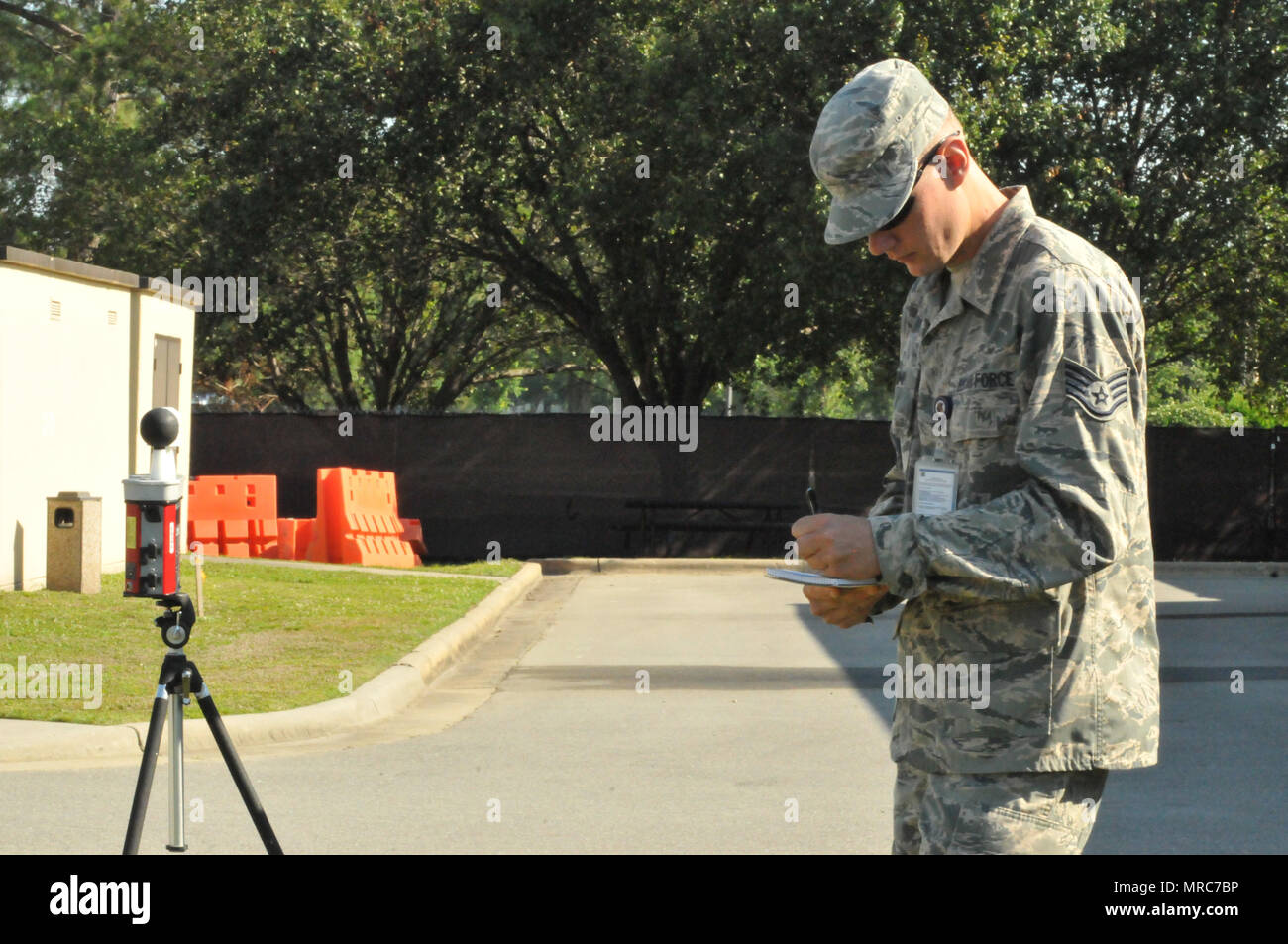 Staff Sgt. Casey Crump records readings from a Wet Bulb Globe Temperature at Seymour Johnson Air Force Base during a June exercise. The WBGT instument is used to determine relative humidity and  outside temperature. It also helps monitor flag readings to determine how long service members can stay outside before getting overheated. (U.S. Air Force photo by Tech. Sgt. Terrica Y. Jones) Stock Photo