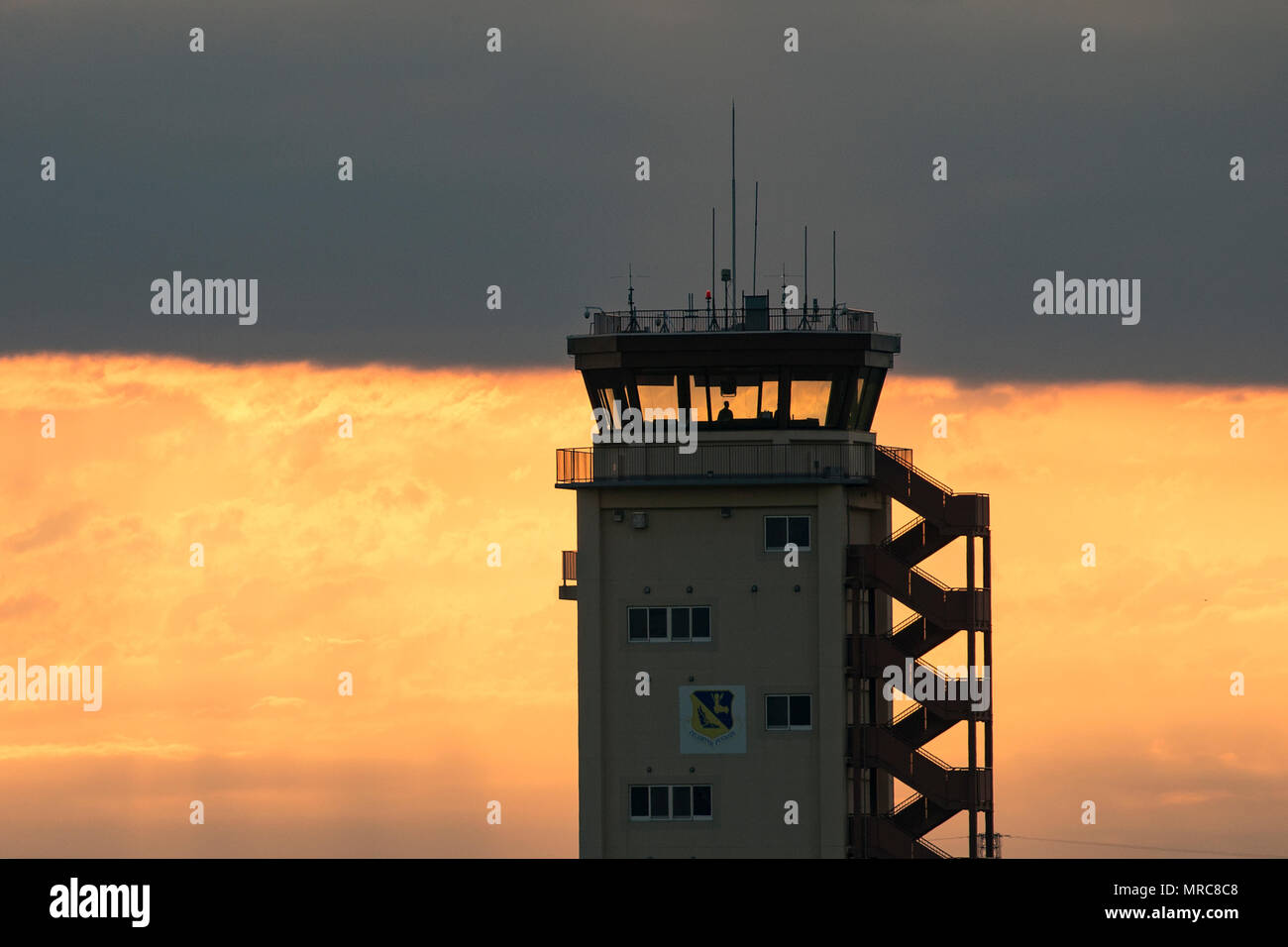 An air traffic controller with the 374th Operations Support Squadron looks out from the control tower at Yokota Air Base, Japan, June 4, 2017. Airmen with the 374th OSS keep yokota’s flightline and sky safe. (U.S. Air Force photo by Yasuo Osakabe) Stock Photo