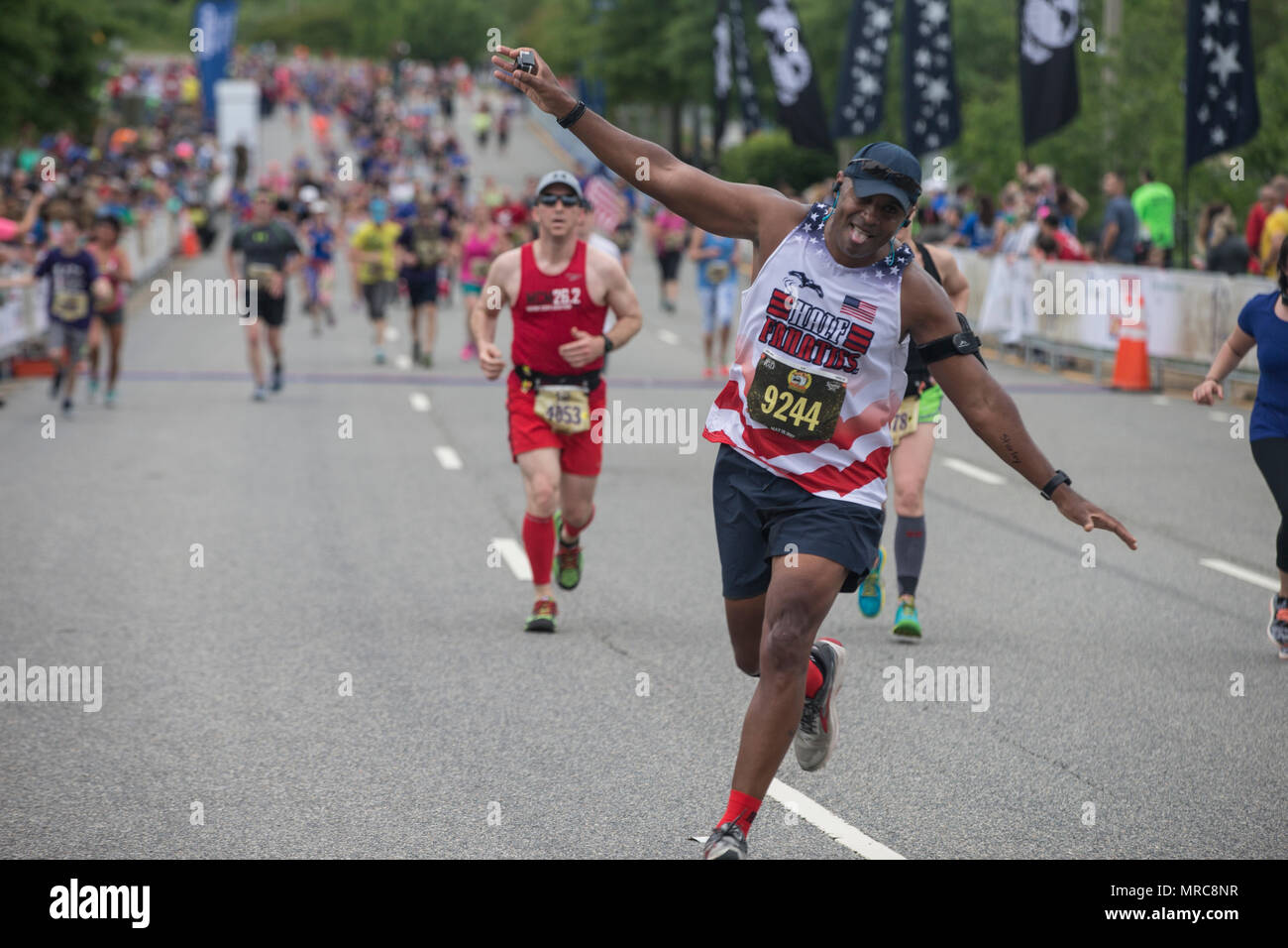 Leodis Smith finishes the final stretch of the Devil Dog Double portion of the 10th Annual Marine Corps Historic Half (MCHH), the 18.1-mile route from the Fredericksburg Expo Center into the historic downtown areas of Fredericksburg, Va., May 21, 2017. The MCHH attracts over 8,000 participants and features the Marine Corps Semper 5ive and the Devil Dog Double. (U.S. Marine Corps photo by Sgt. John M. Raufmann) Stock Photo