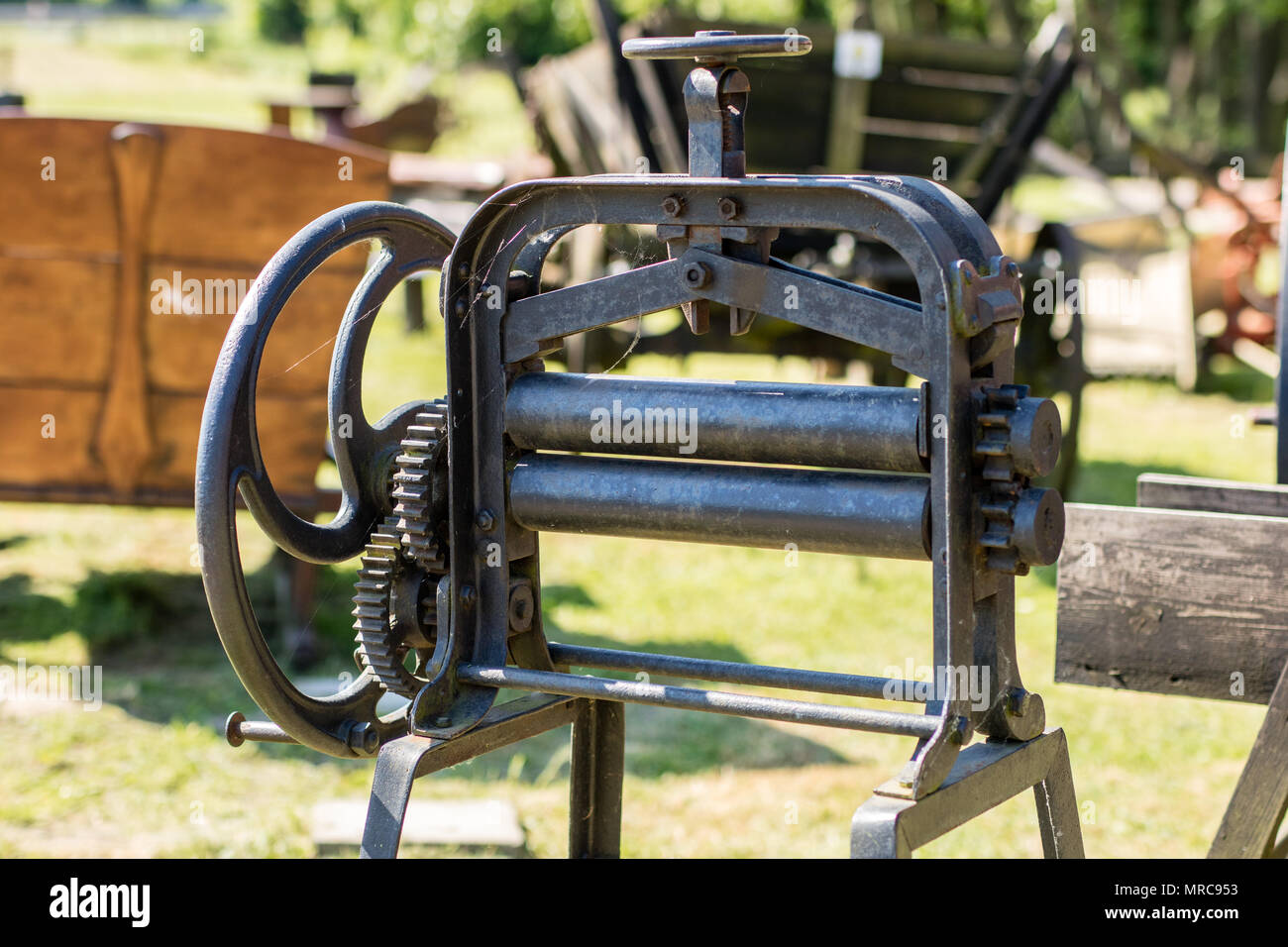 Old mangle for housework. Devices that facilitate housework in an old house. Season of the spring. Stock Photo