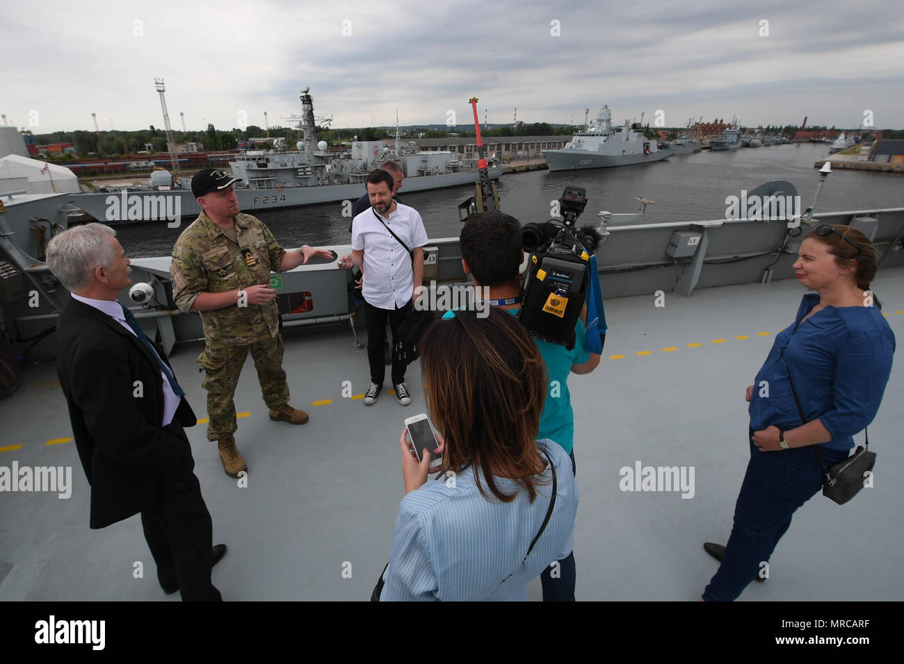 170603-N-JI086-417 - SZCZECIN, Poland (June 3, 2017) Danish navy Cmdr. Anders Jessing, executive officer of the Danish Absalon-class combat support ship HDMS Absalon (L16), gives Polish media a tour of the ship during the pre-sail portion of exercise BALTOPS 2017, June 3, 2017. BALTOPS is an annual U.S.-led, Naval Striking and Support Forces NATO-executed, multinational maritime exercise in the Baltic Sea region designed to enhance flexibility and interoperability among its participants. (U.S. Navy photo by Mass Communication Specialist 3rd Class Ford Williams/Released) Stock Photo