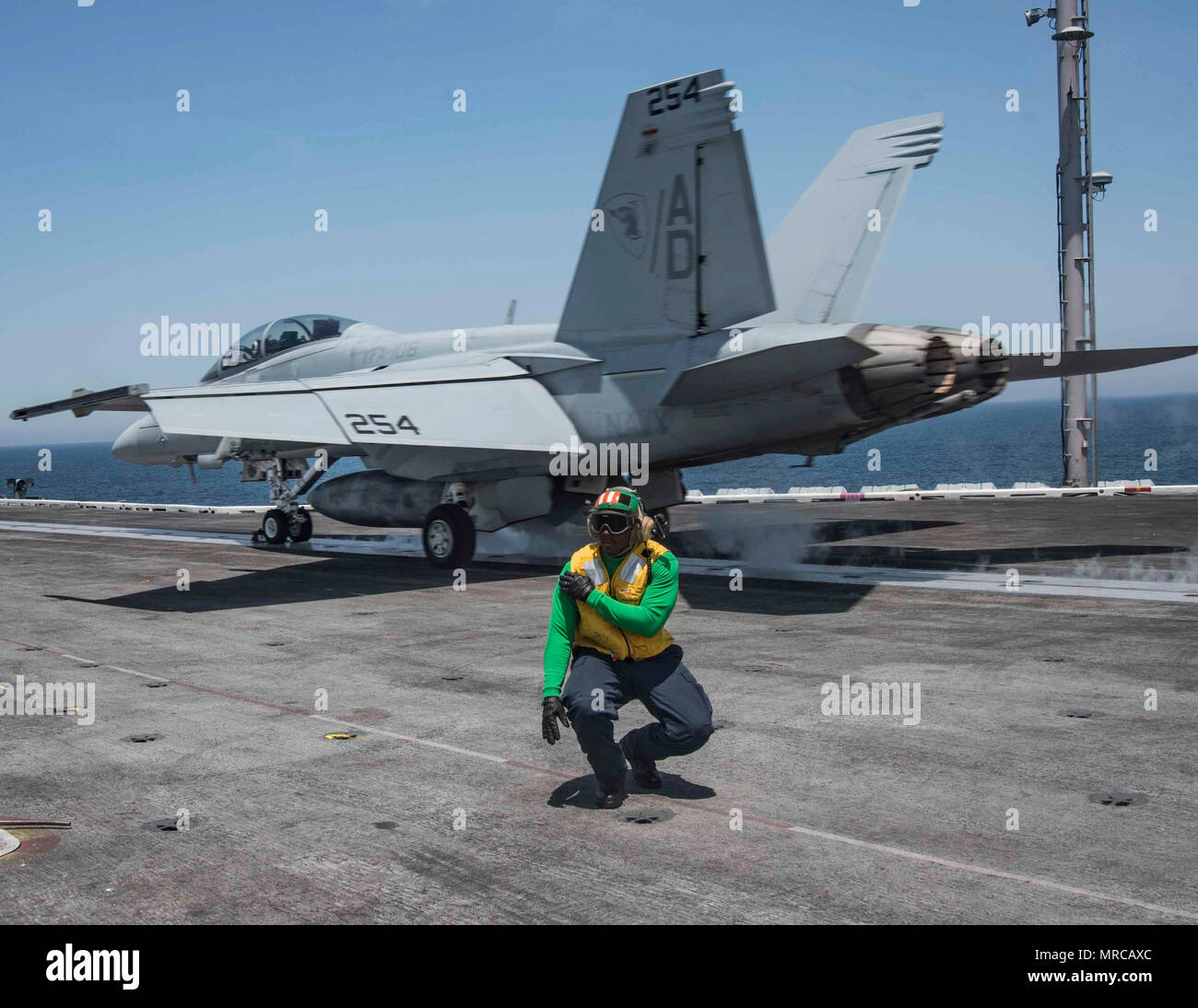 170601-N-KJ380-314  ATLANTIC OCEAN (June 1, 2017) Aviation Boatswain's Mate (Equipment) 2nd Class Ladarrius Robinson signals an F/A-18E Super Hornet assigned to the Gladiators of Strike Fighter Squadron (VFA) 106 for launch on the flight deck of the aircraft carrier USS Dwight D. Eisenhower (CVN 69) (Ike). Ike is currently conducting aircraft carrier qualifications during the sustainment phase of the Optimized Fleet Response Plan (OFRP). (U.S. Navy photo by Mass Communication Specialist Seaman Neo B. Greene III) Stock Photo