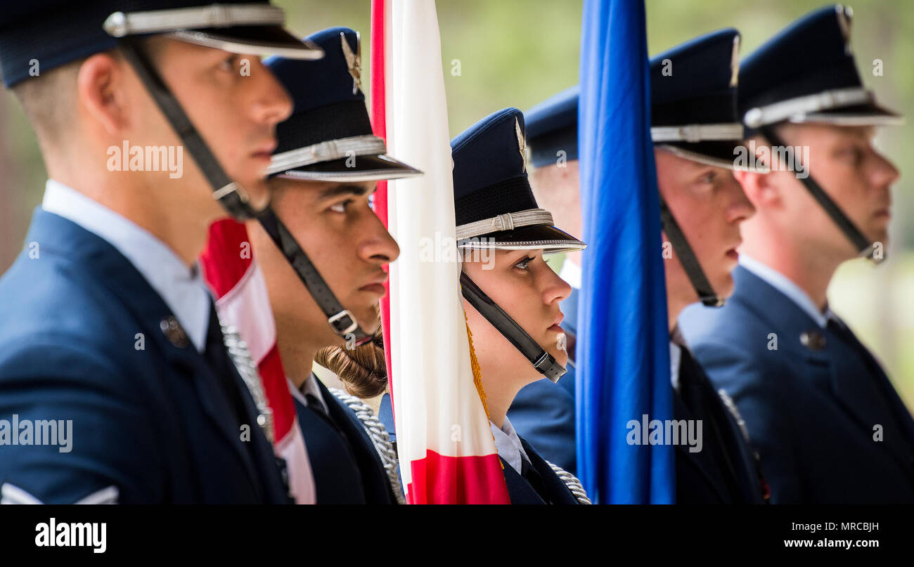 A color guard stands at parade rest prior to the Team Eglin Honor Guard graduation ceremony at Eglin Air Force Base, Fla., June 1. Approximately 12 new Airmen graduated from the 120-plus-hour course. The graduation performance includes flag detail, rifle volley, pall bearers and bugler for friends, family and unit commanders. (U.S. Air Force photo/Samuel King Jr.) Stock Photo